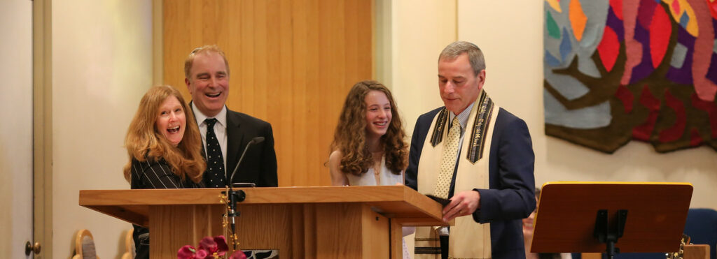 A man and a young woman stand at a podium during a formal ceremony.