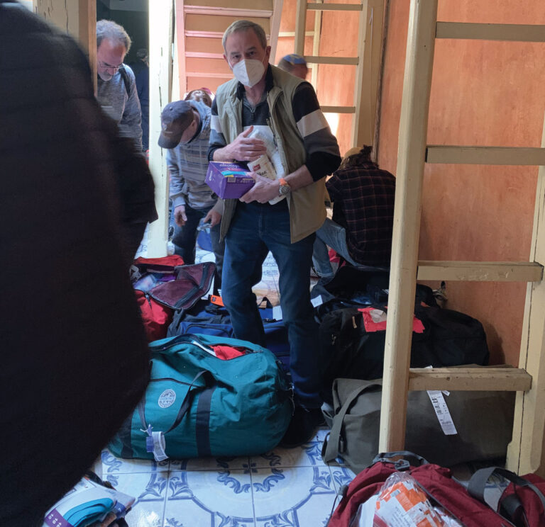Man organizing supplies in a small room.