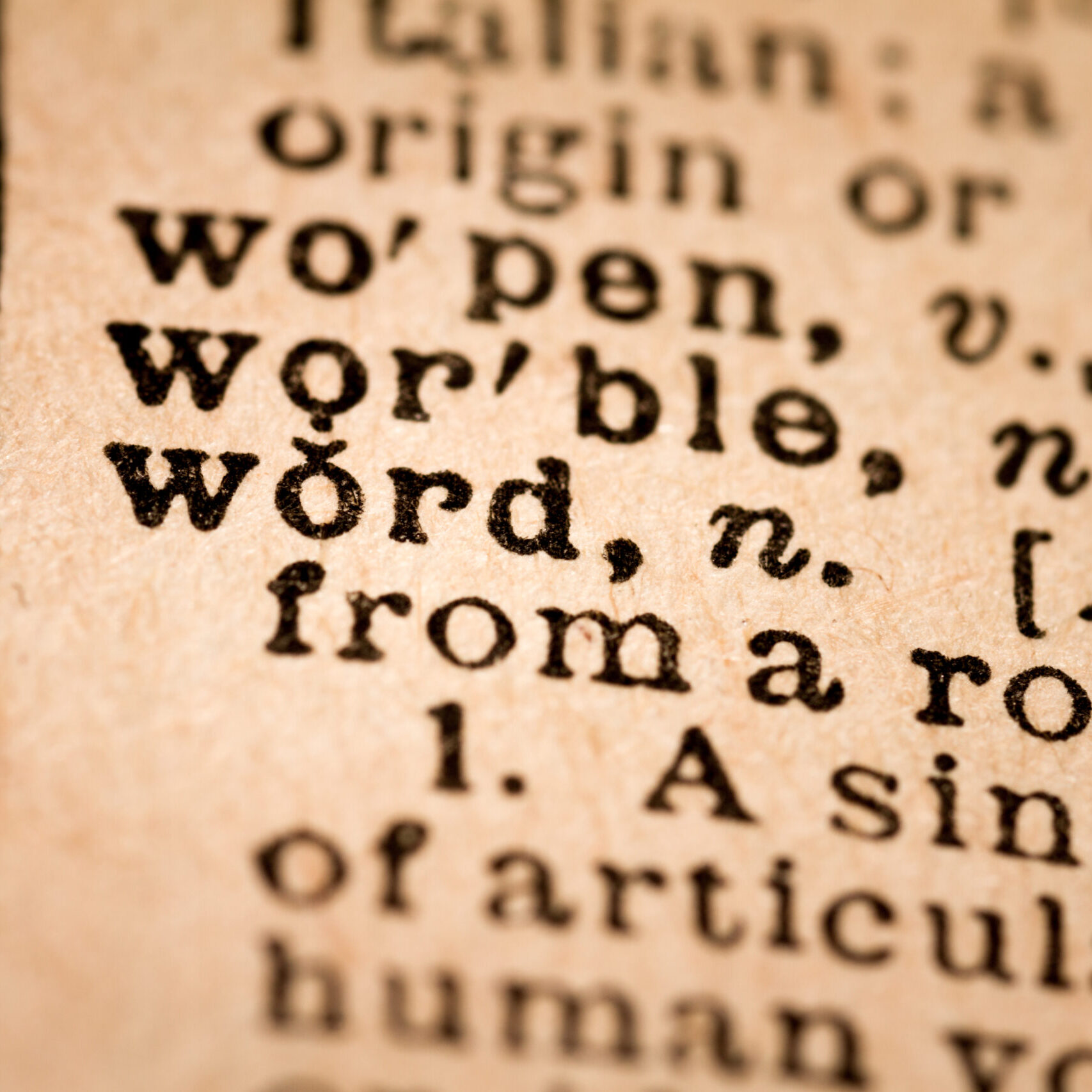 Close-up of an Opened Dictionary showing the Word WORD October 1st, 2015 - Montreal, Canada. Close-up of an Old 1945 Webster Vintage Dictionary showing the Word WORD