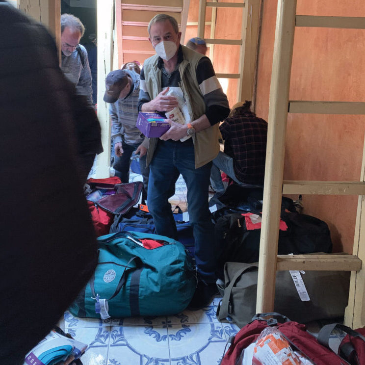 Man organizing supplies in a small room.