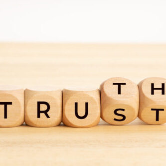Truth or trust concept. Text on wooden blocks. White background. Copy space Truth or trust concept. Text on wooden blocks. White background. Copy space